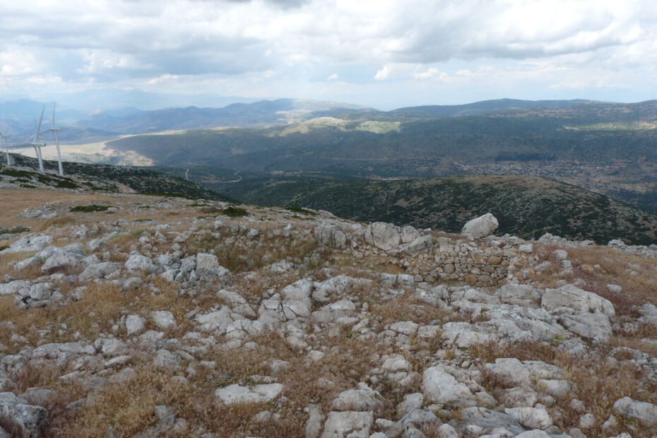 Rocky Mountain slope, with wind turbines in the distance.