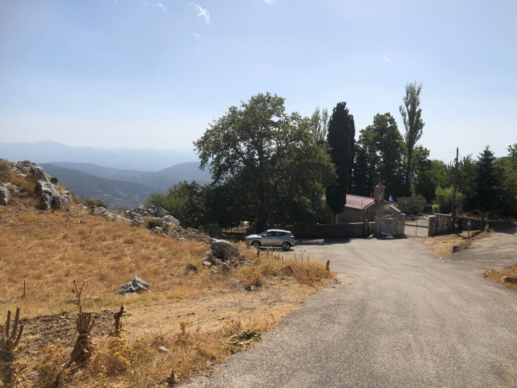 Road with trees and monastery building.