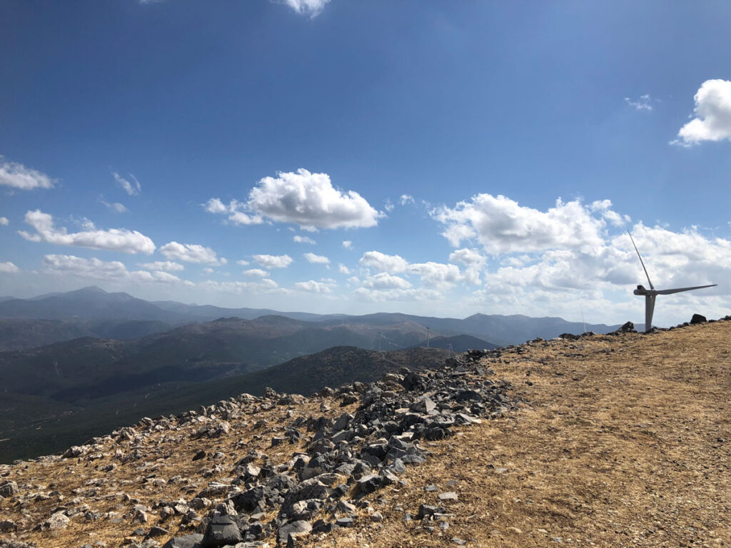 Mountain summit with wind turbine.