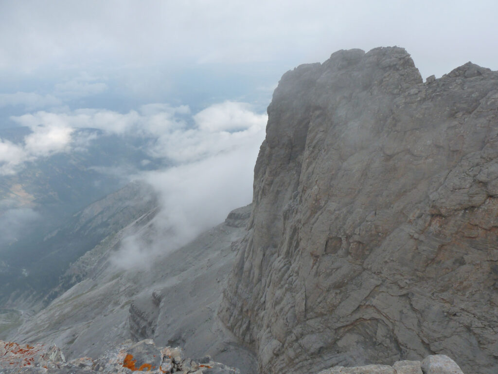 Cliff face and cloud viewed from above.