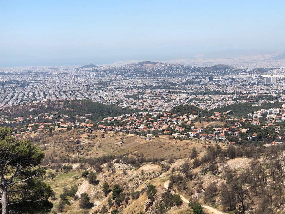 Distant view of city and hills of Athens, looking down from mountain slopes.