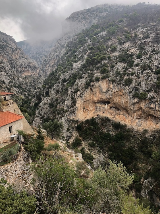 Monastery with cliffs behind.