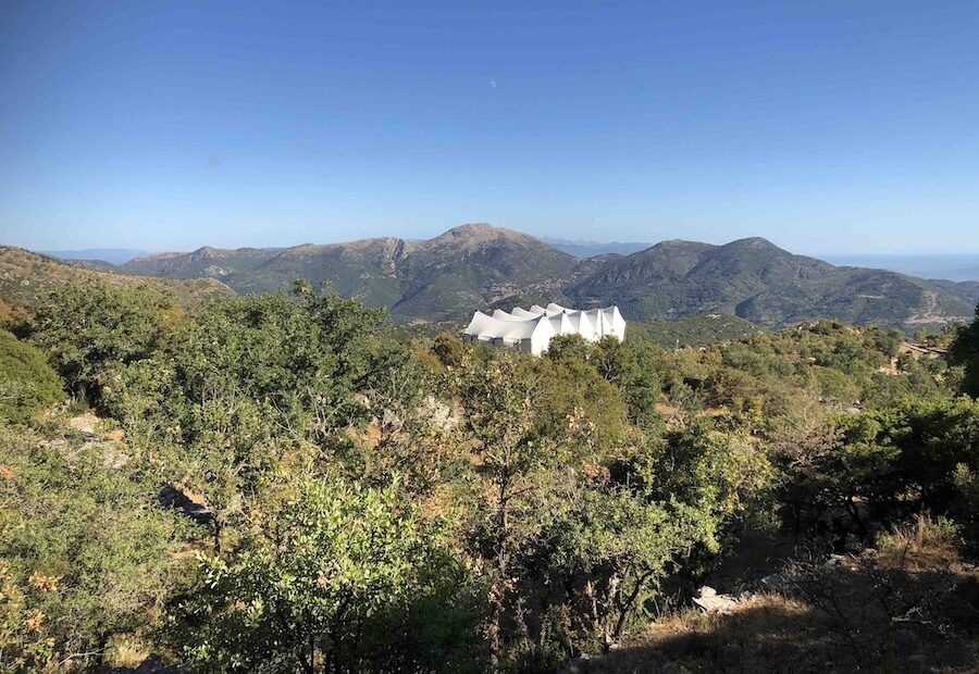 View of hills with the white protective tent of the temple of Apollo at Bassae